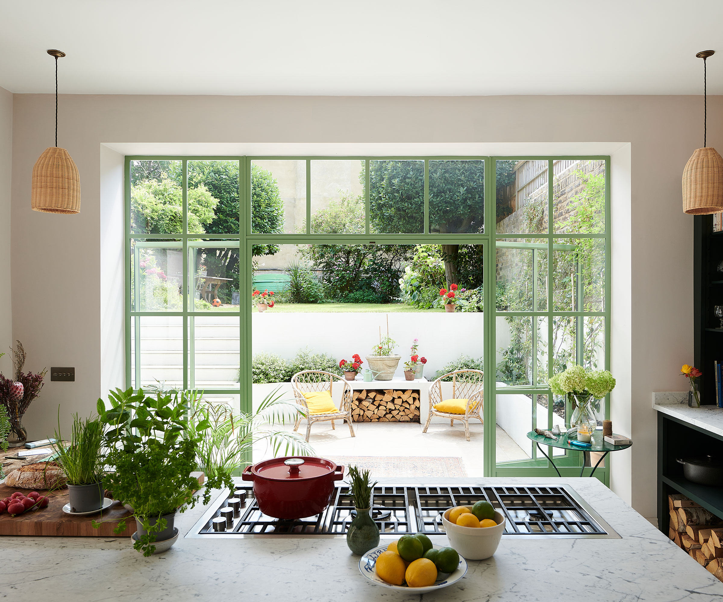 kitchen in basement conversion with green doors to outside sunken garden