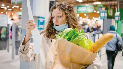 Woman looking at a till receipt