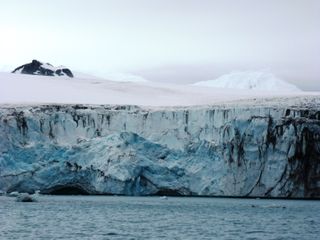 The calving front of an Antarctic glacier, where ice falls into the sea.