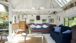 Insulating a conservatory roof — conservatory interior with sofas and flowers