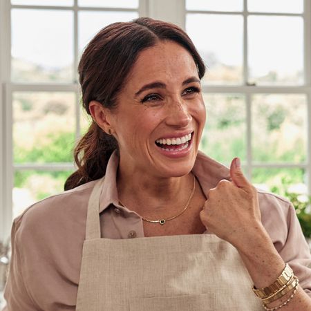 Meghan Markle wears a pink shirt and neutral apron in a still from Netflix show With Love, Meghan