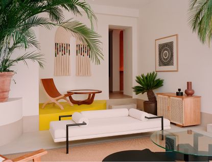 Interior view of the Luteca showroom with palm trees and modernist Mexican furniture