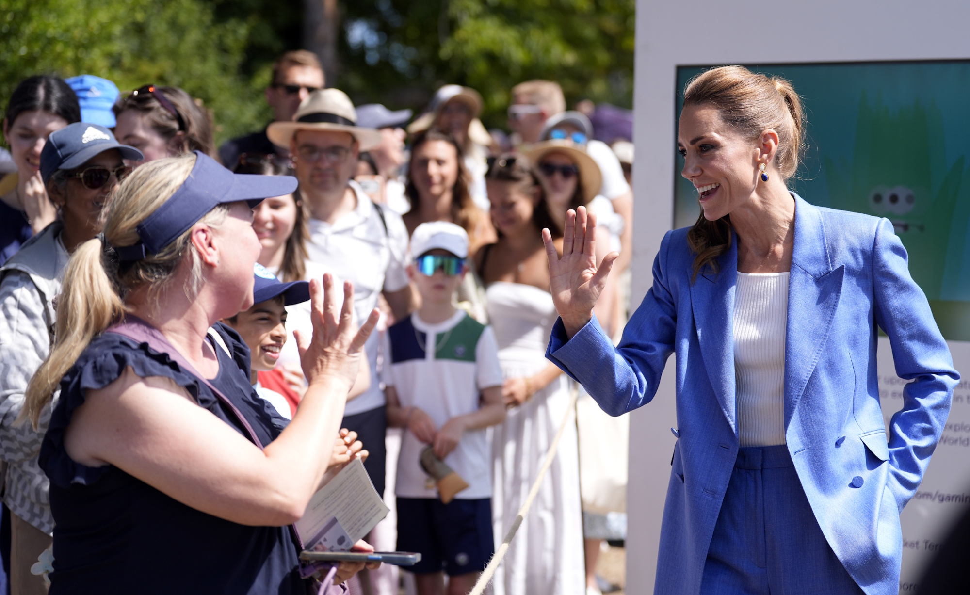 Catherine, Princess of Wales speaks to members of the public queueing for entry during a visit on day four of the 2026 Wimbledon Tennis Championships on July 2, 2026 in London, England.
