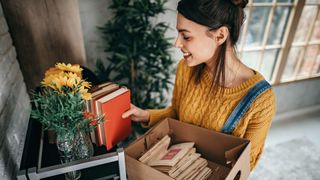 A woman tidies a shelf