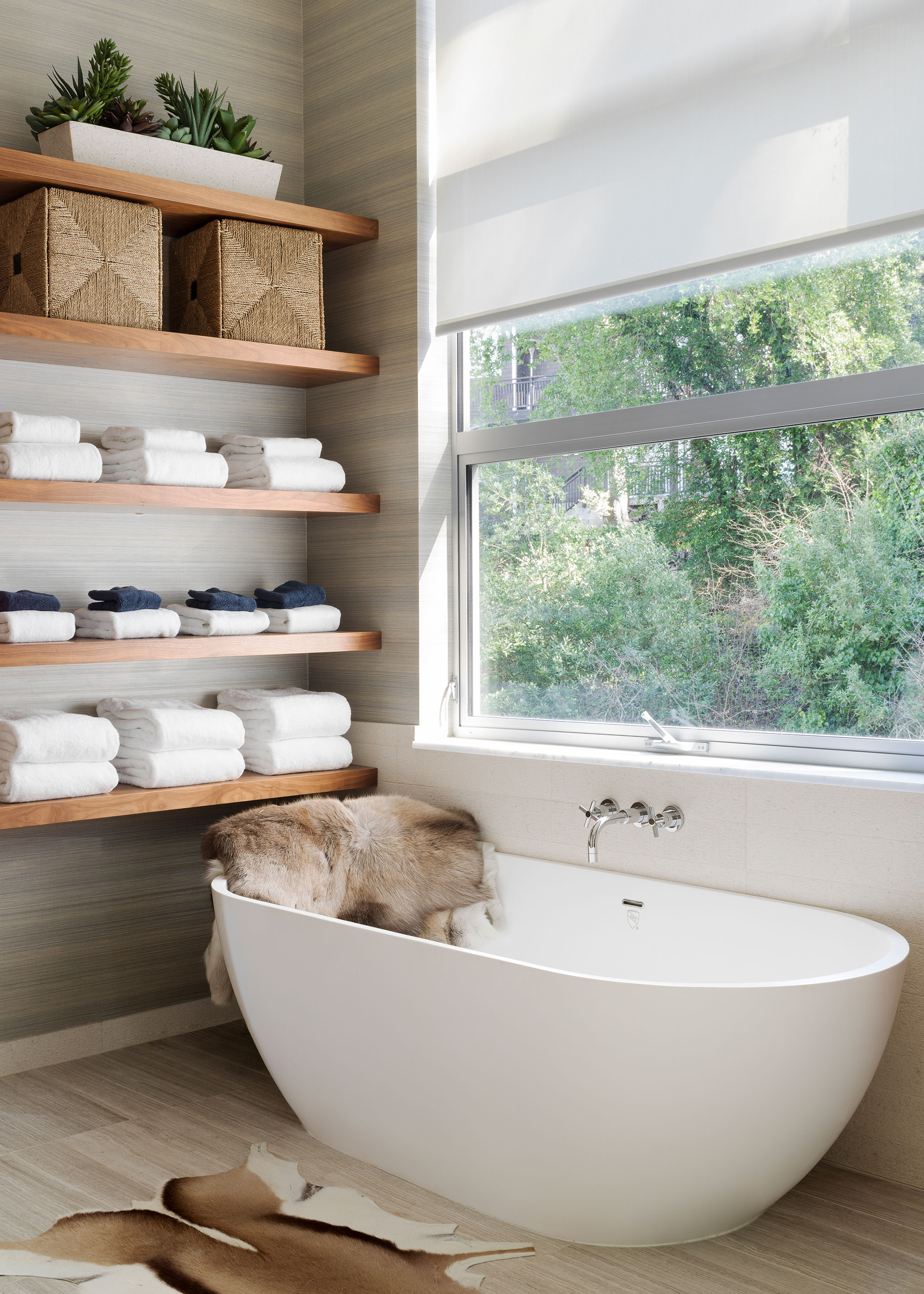 modern white bath tub with bathroom shelving