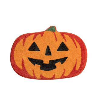 A Halloween pumpkin bath mat