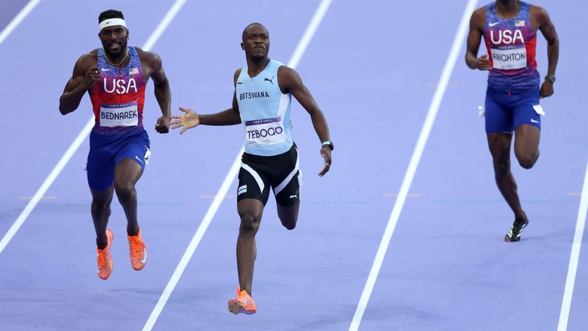  Letsile Tebogo (C) of Team Botswana crosses the finish line to win the gold medal in the Men&#039;s 200m Final on day thirteen of the Olympic Games Paris 2024 at Stade de France on August 08, 2024 in Paris, France.
