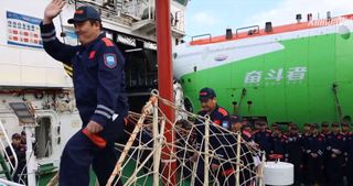 A still from a video shows the submersible returning to port and its pilots disembarking after the weeks-long expidition.