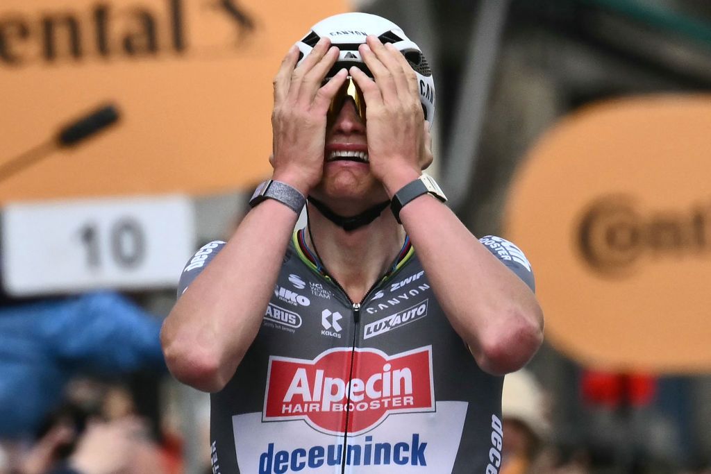 Dutch Mathieu Van Der Poel of team Alpecin-Deceuninck celebrates as he crosses the finish line to win the Milan - Sanremo one-day classic cycling race, on March 22, 2025. Dutch Mathieu Van Der Poel of team Alpecin-Deceuninck won the race ahead of Team Ineos&#039; Italian rider Filippo Ganna and Team UAE&#039;s Slovenian rider Tadej Pogacar, third. (Photo by Marco BERTORELLO / AFP)