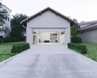 Open door of a modern garage with a concrete driveway at the urban district