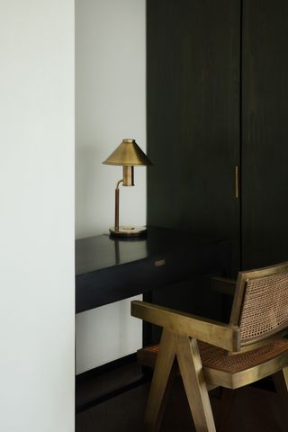A corner desk with a table lamp