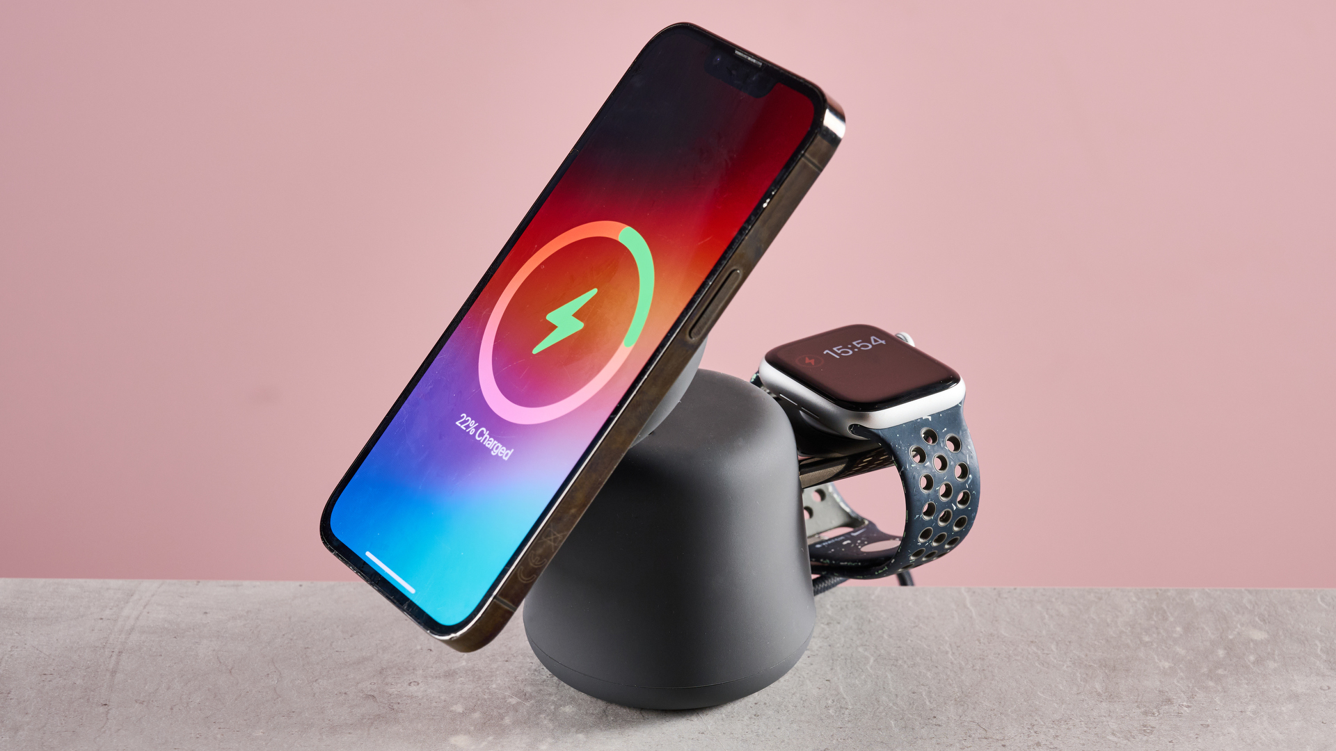 There is an iPhone charging on the 2-in-1 Belkin charger it standing up, and an Apple Watch can be seen charging on the rear charing module.