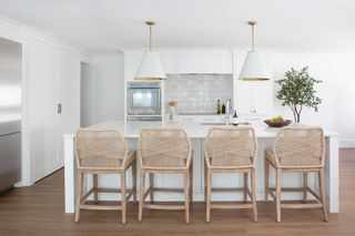 a white kitchen with a large island