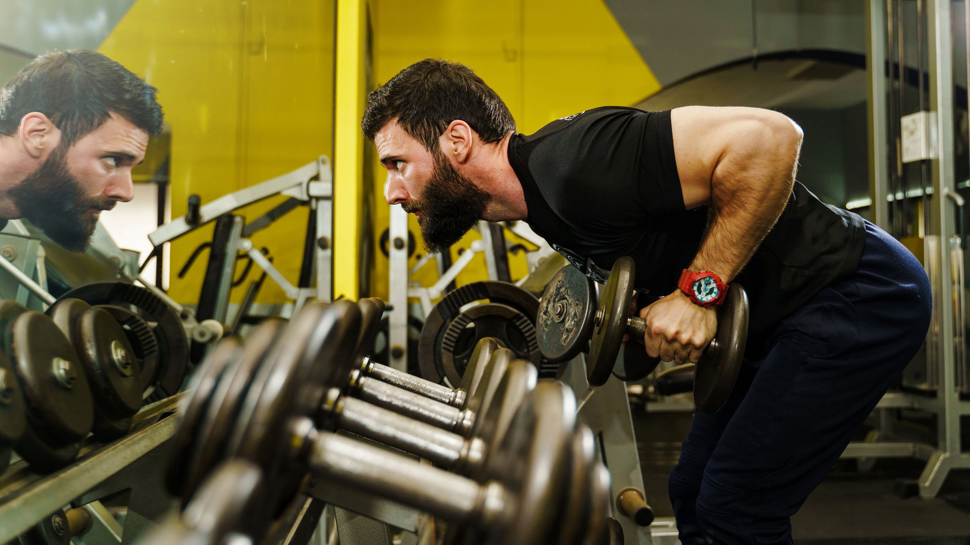 Man doing dumbbell row in gym