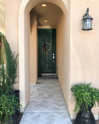 Green door with painted brick path