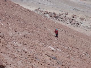 A researcher climbs up Mount Llullaillaco in Argentina.