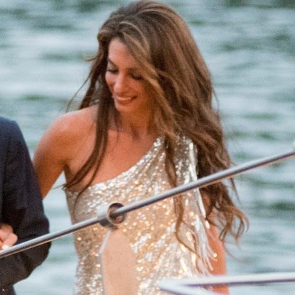 Amal Clooney on a boat wearing a silver sequin dress
