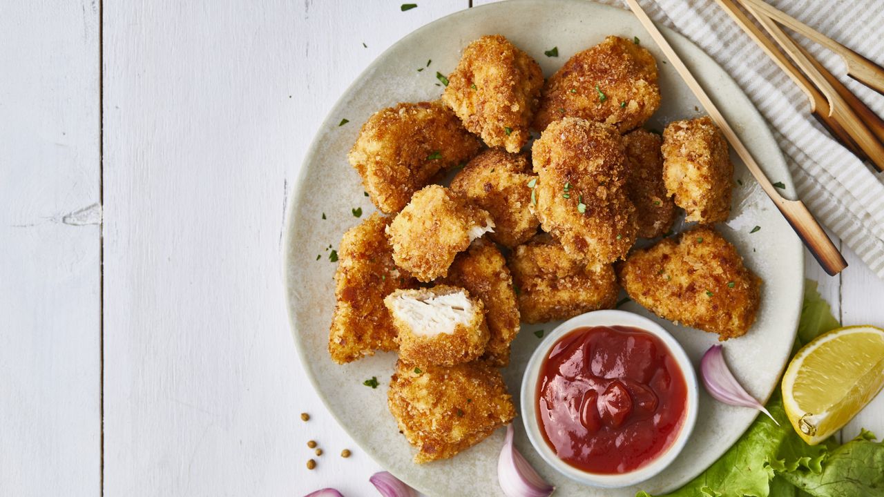 Plate of homemade Rice Krispie chicken nuggets with ketchup