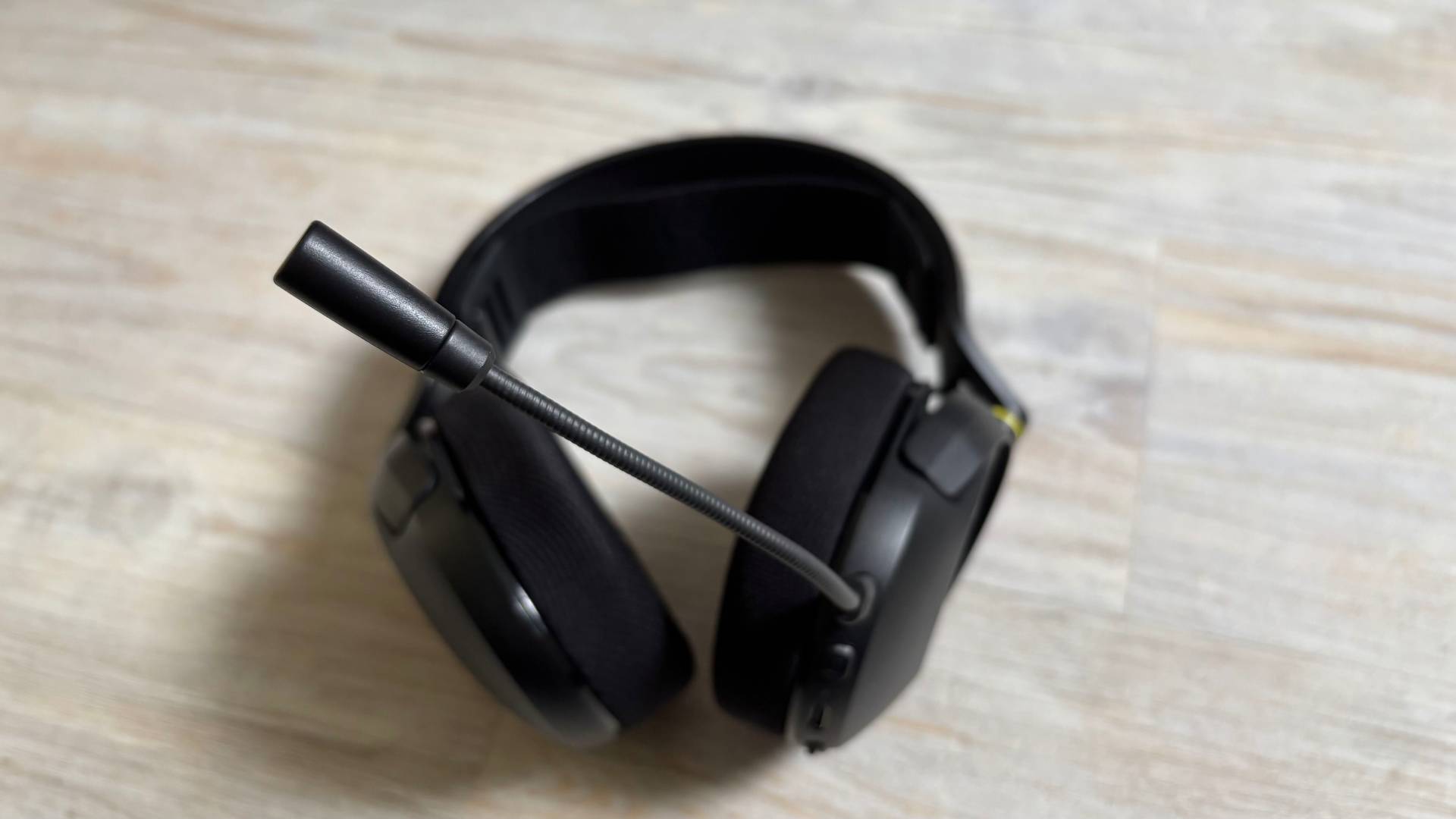 Corsair HS35 v3 headset with mic plugged in close up against a white hardwood floor