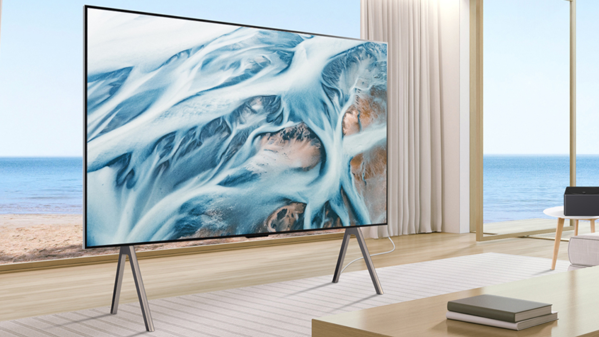 The LG M5 OLED in a posh, seaside home. It is displaying abstract, blue-colored imagery.