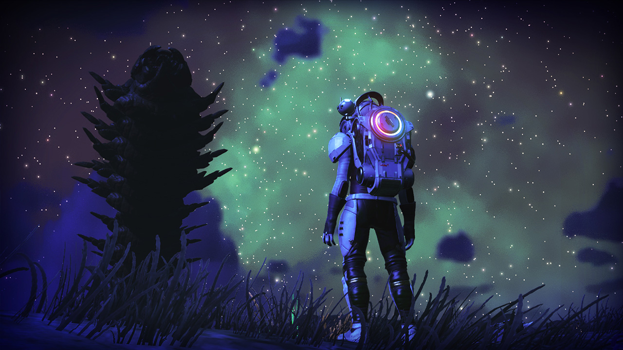 Still from the video game No Man's Sky. An astronaut is standing in a field next to an alien tree looking up at the vast swirl of stars above them.