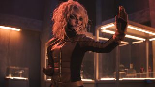 A beaten up M3GAN adopts a fighting stance in M3GAN 2.0.