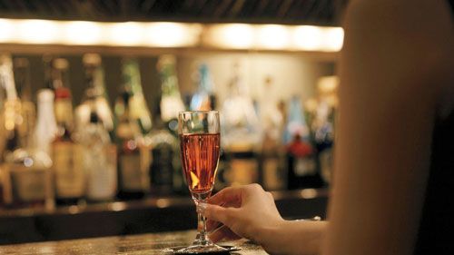 woman with a drink at a bar