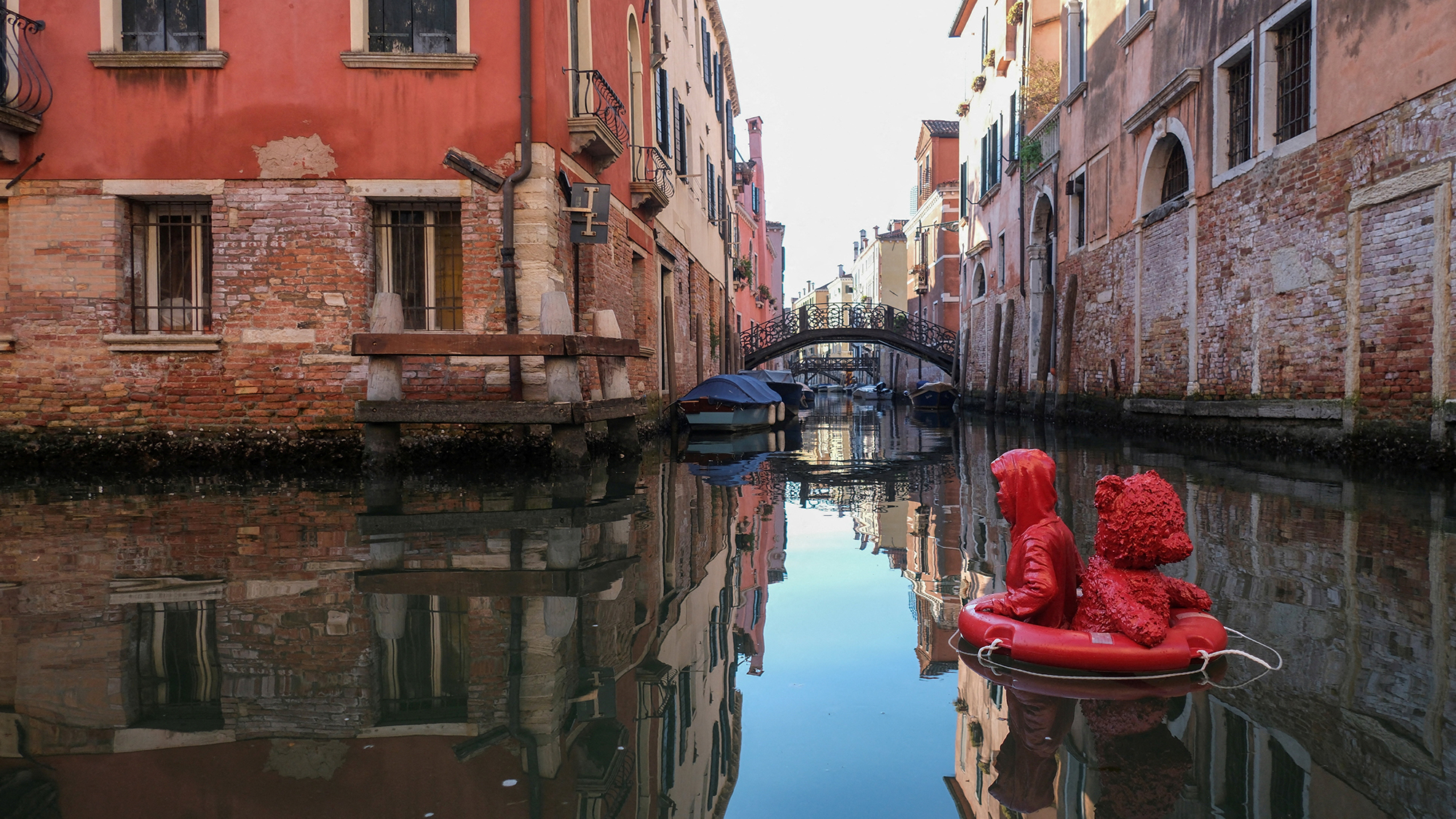 French artist James Colomina&amp;rsquo;s artwork &amp;ldquo;Nothing Serious&amp;rdquo;, depicting a child drifting on a lifebuoy with a teddy bear, floats on the Rio di San Felice in Venice, Italy