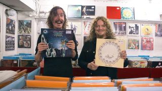 A photograph of Mikael Åkerfeldt and Opeth holding up records