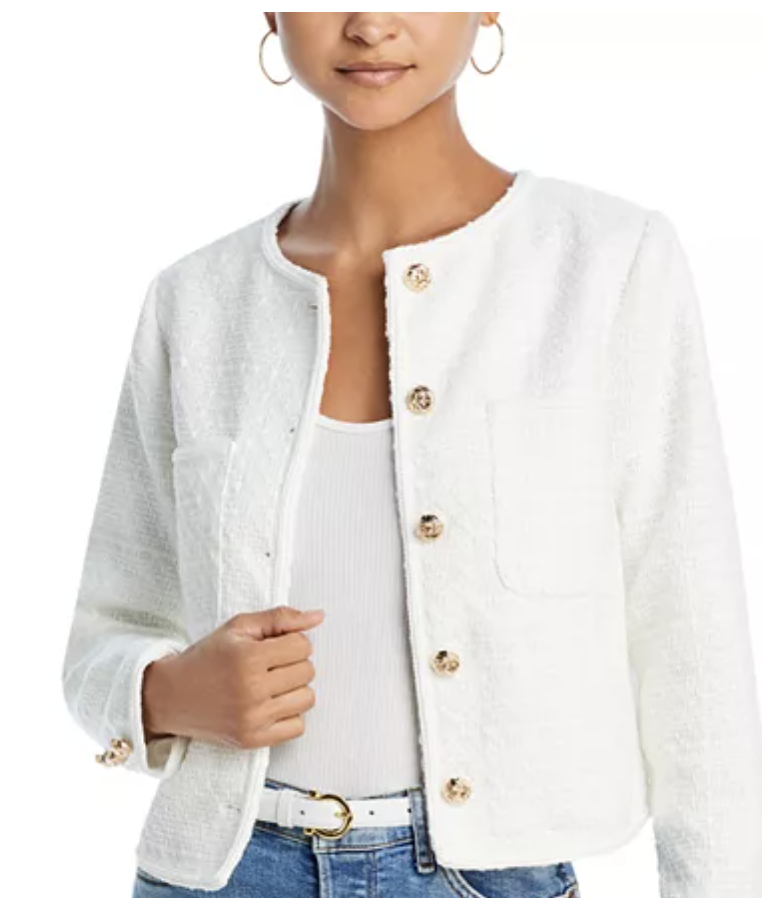 A model wearing a cropped white jacket