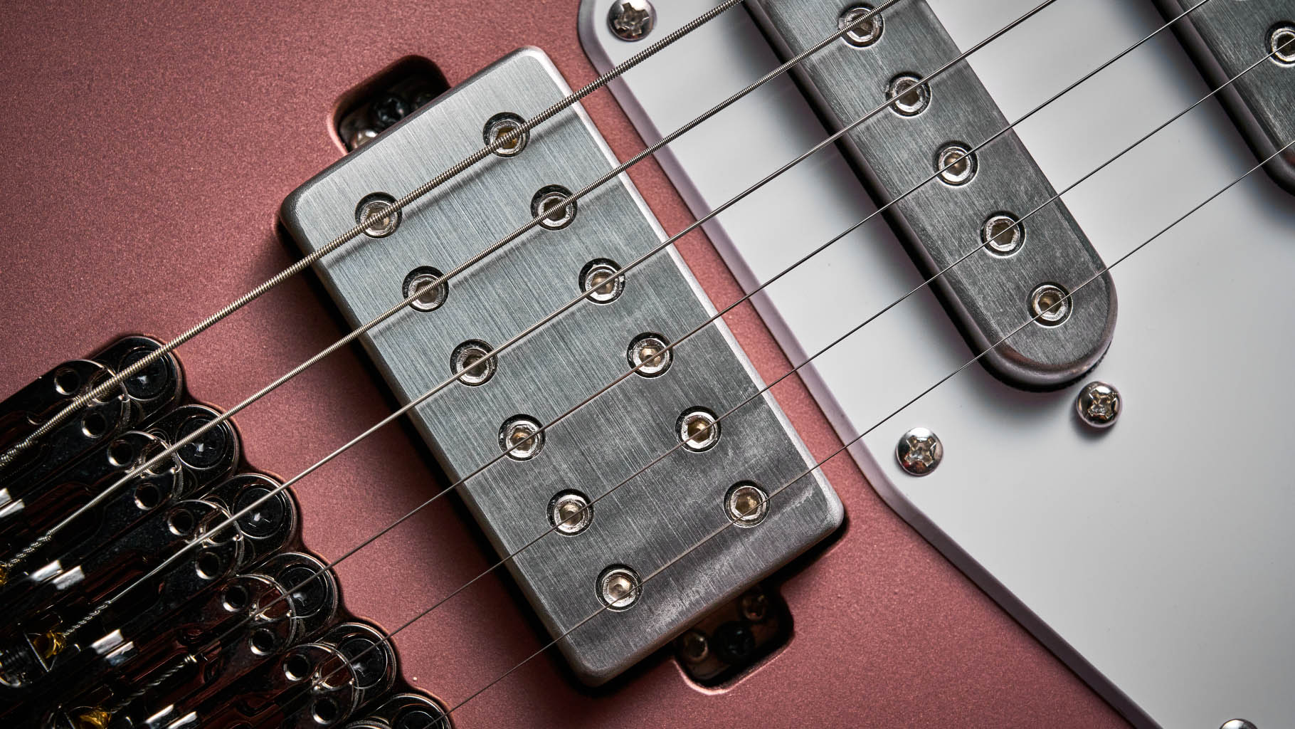 Ibanez Q54W: the headless electric guitar is finished in Copper Metallic Matte and photographed against a thick light-tan colored carpet.