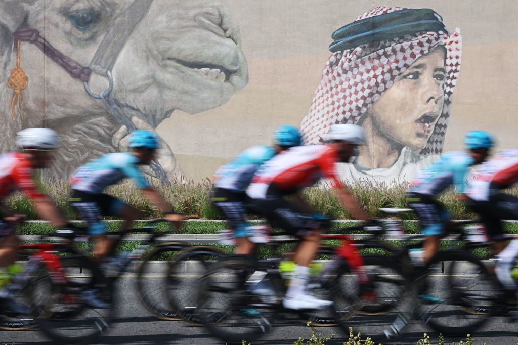 ABU DHABI UNITED ARAB EMIRATES FEBRUARY 22 A general view of the peloton passing in front of a graffiti decorating a wall during the 7th UAE Tour 2025 Stage 6 a 165km stage from Abu Dhabi Cycling Club to Abu Dhabi Breakwater UCIWWT on February 22 2025 in Abu Dhabi United Arab Emirates Photo by Dario BelingheriGetty Images