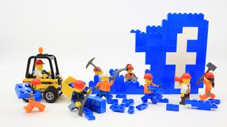 Lego builders dismantling the Facebook logo