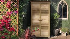 a small garden shed with louvred doors