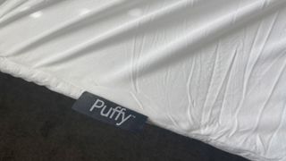 Close up of the Puffy Deluxe Mattress Topper's label