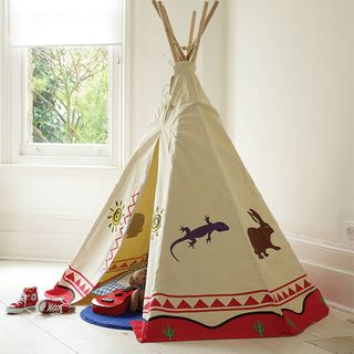 room with wooden floor and teepee with animal design