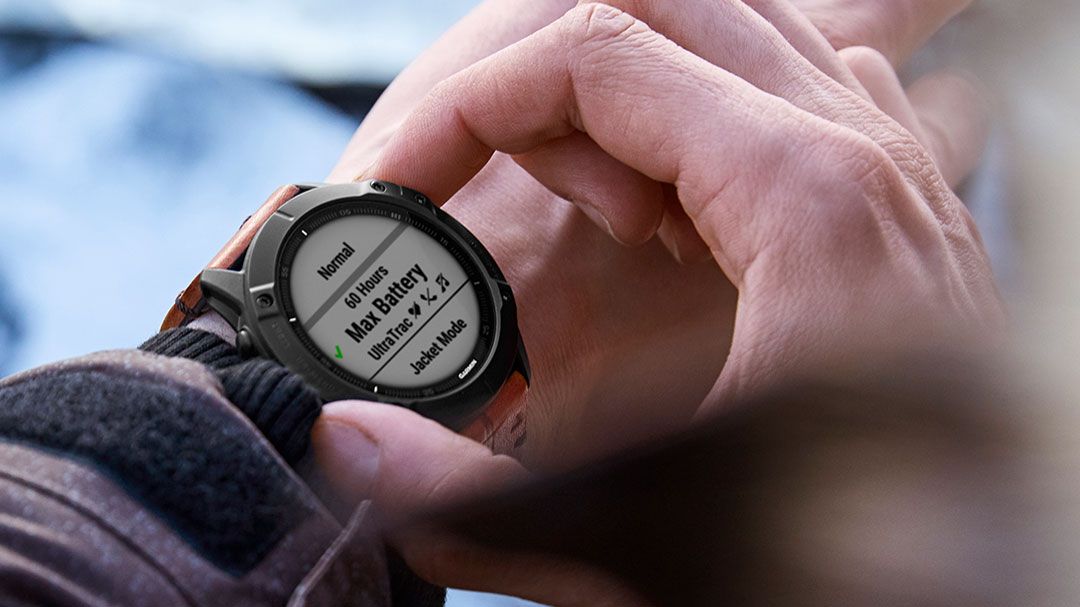 Man adjusting settings on Garmin Fenix 6 watch