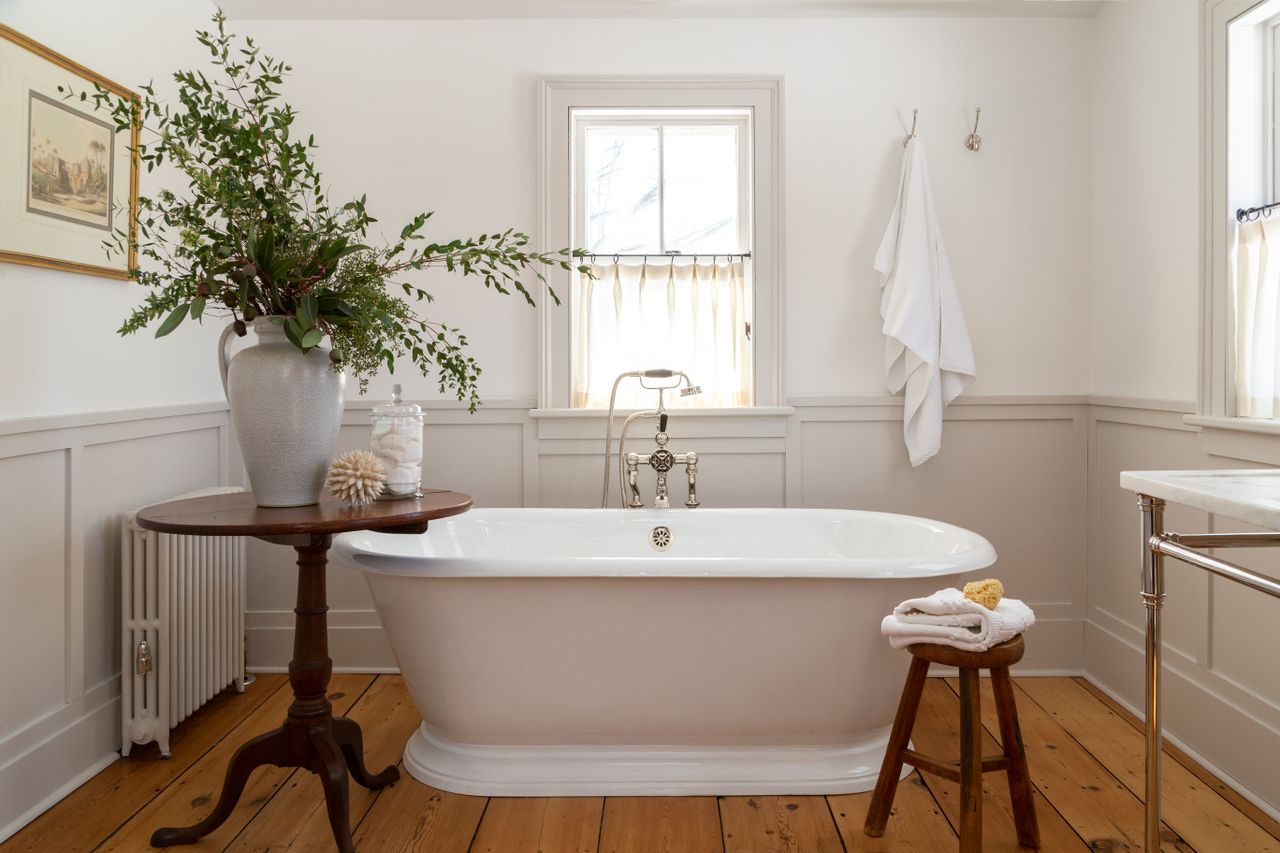 Bathroom with wooden floors and freetstanding bath