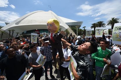 Protesters hit a Donald Trump piñata outside of a Trump rally in Anaheim, California.