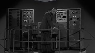 A man fiddling with a large vintage computer in No Time Like The Past in The Twilight Zone