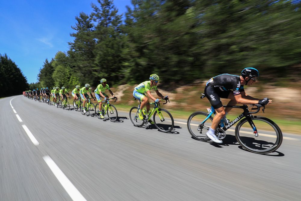 The peloton speeds along at the Tour de France.