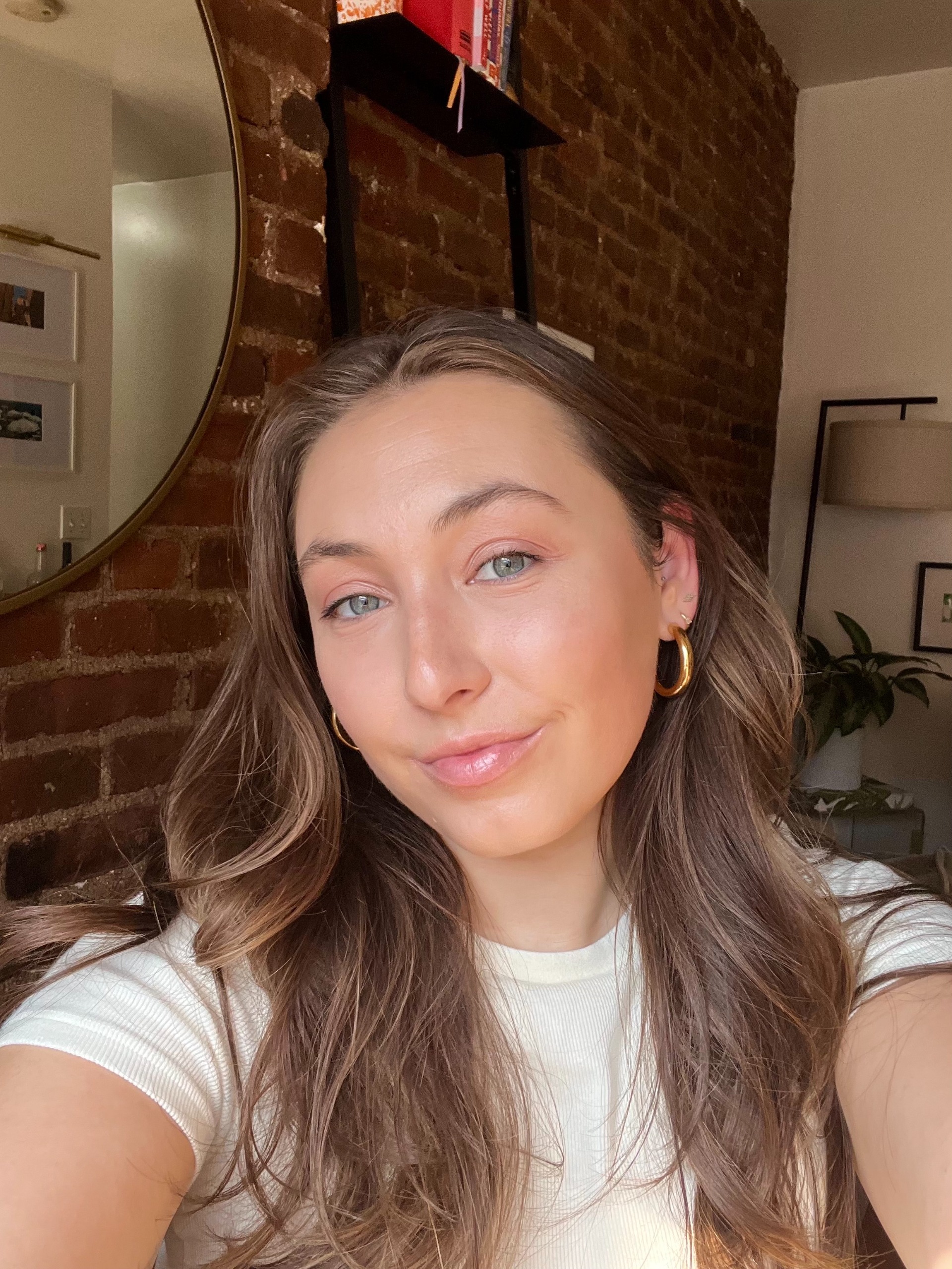 a white woman with light brown hair in a white t shirt