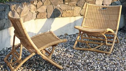 rattan chairs on a pebble patio