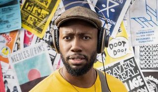 Woke Lamorne Morris with his headphones on, in front of a board