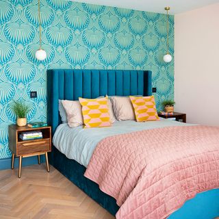 bedroom with green wallpaper and blue bed