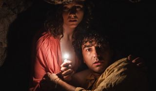 Thomasin McKenzie and Alex Wolff huddling for safety in the cave in Old.