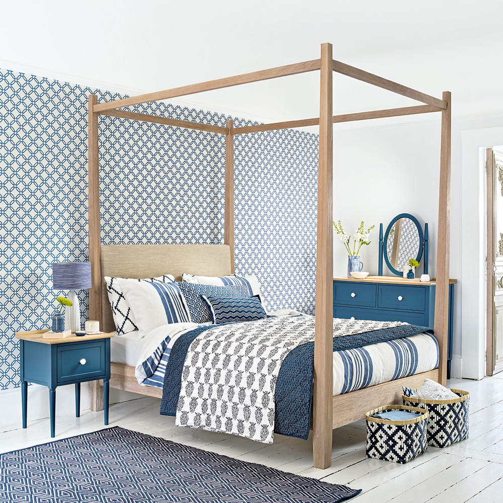 bedroom with blue designed white wall and wooden flooring