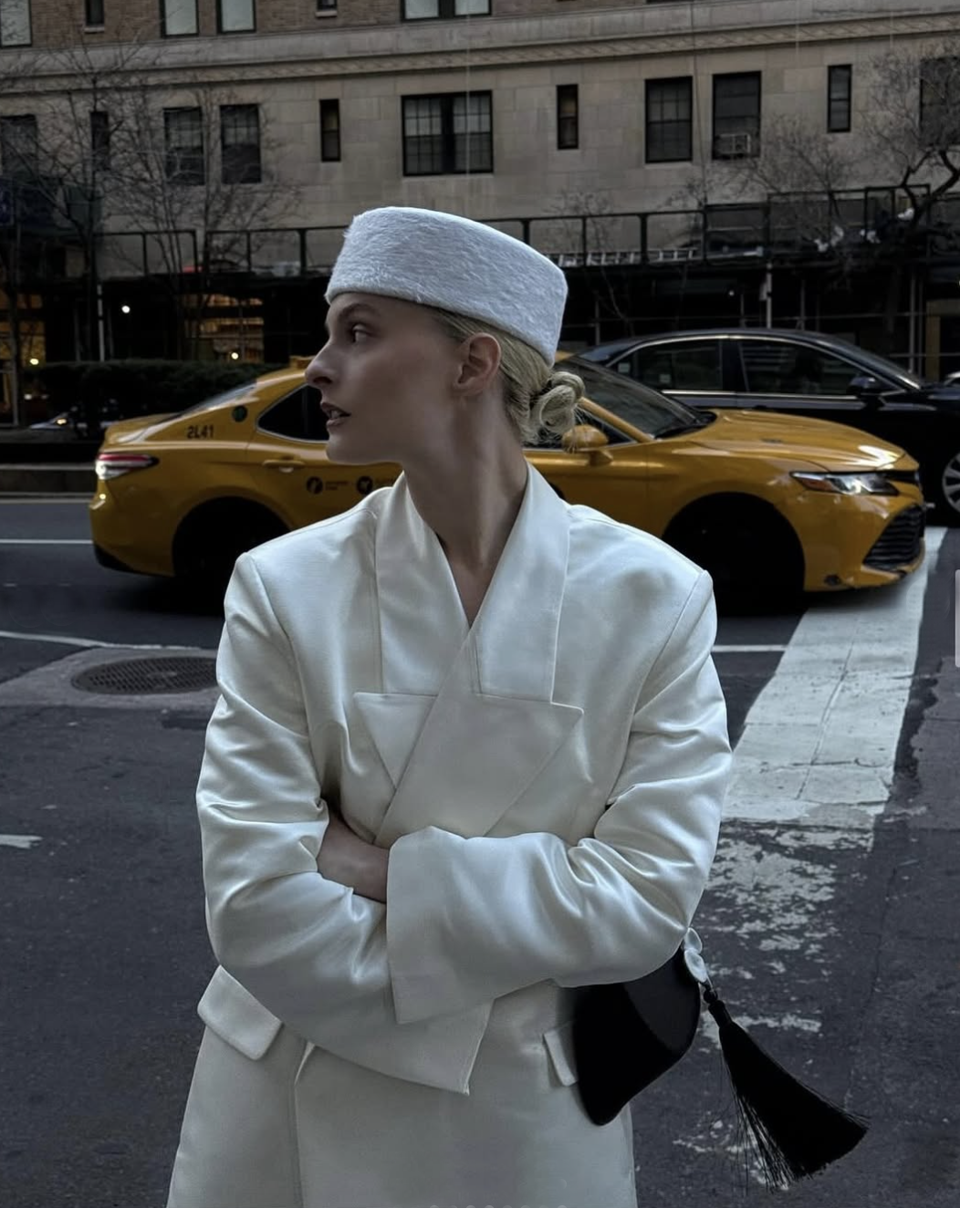 woman in white suit and pillbox hat