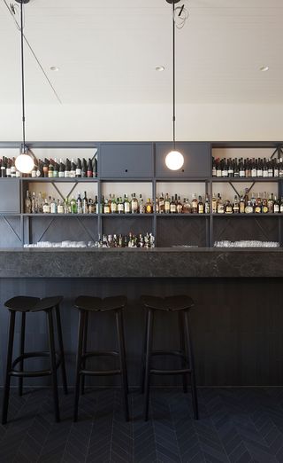 The Ugly Duckling, a new cocktail bar with black stools.