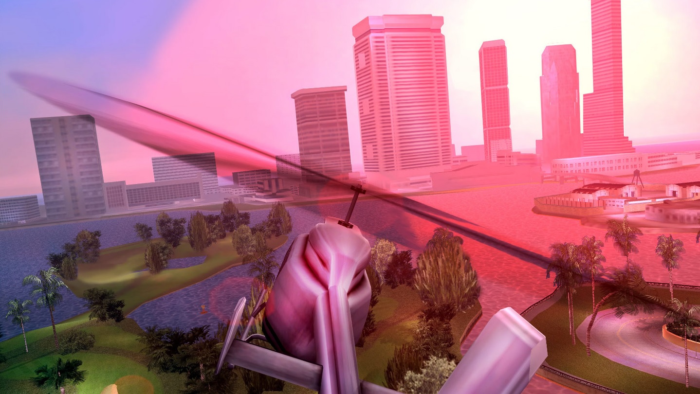 GTA: Vice City - Un helicóptero sobrevuela una ciudad de rascacielos al atardecer